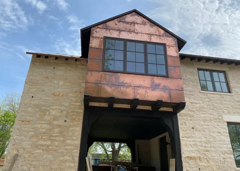 Copper metal panel facade on a stone building for Skylight Installation in Boulder