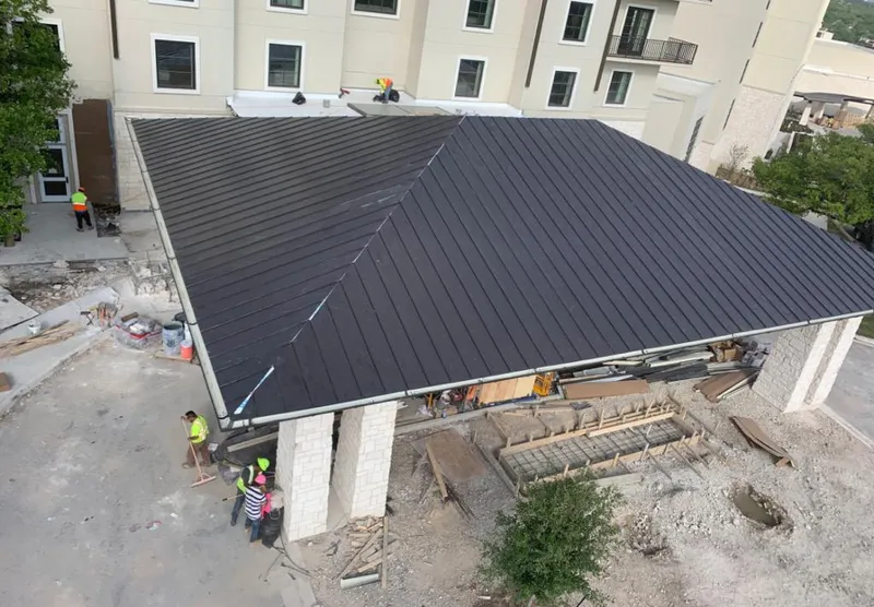 Metal roofing installation team working on a commercial building in Boulder
